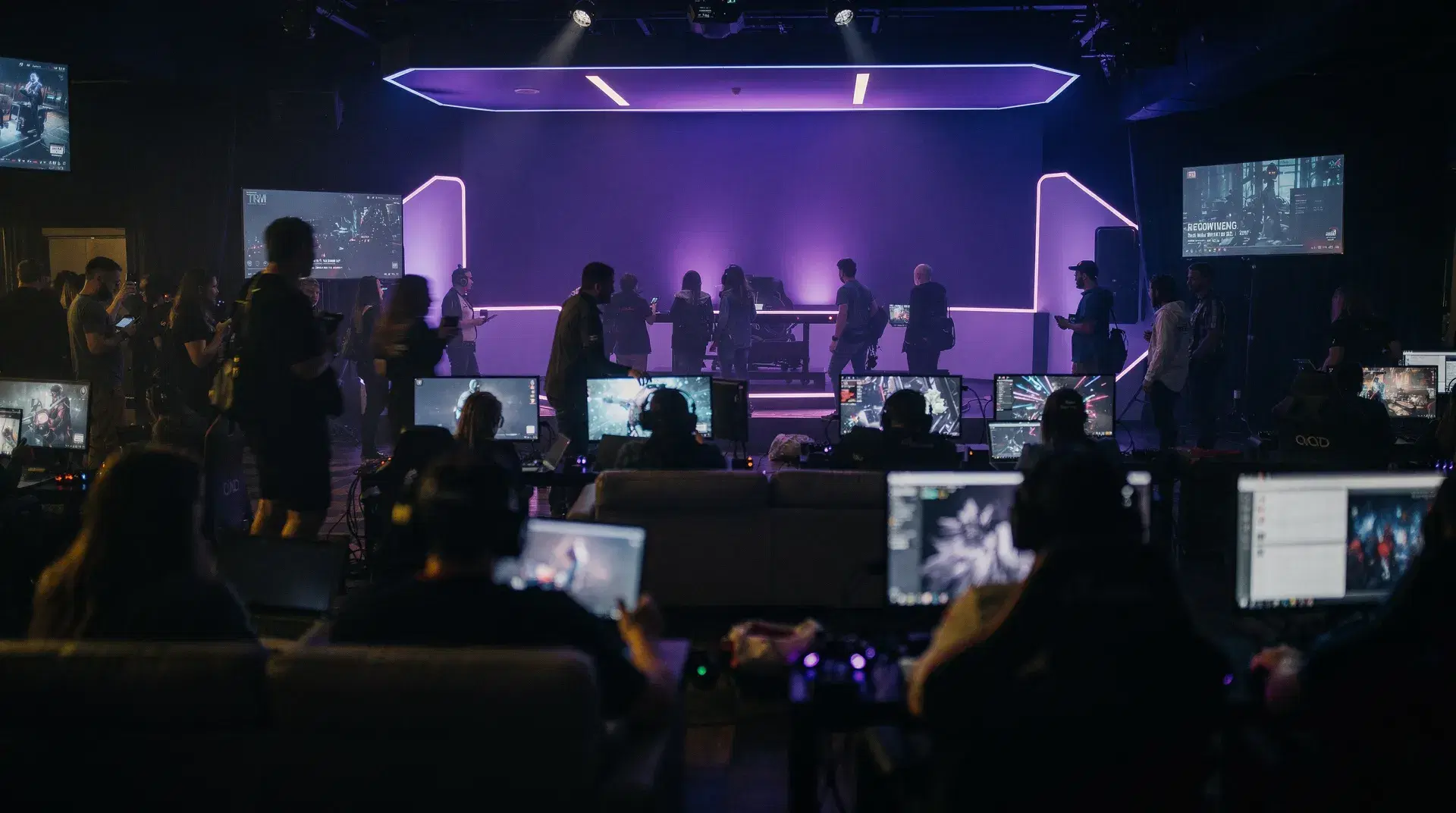 A vibrant gaming community lounge event lit with purple stage lighting